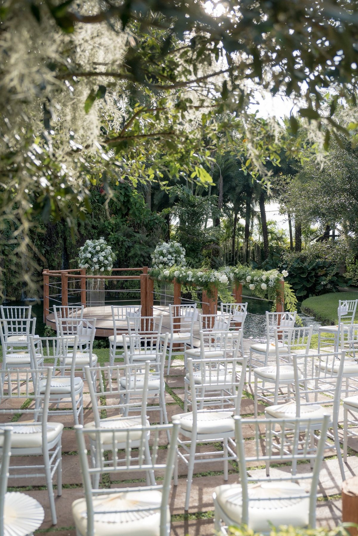 White ceremony chairs for a small wedding at Longan’s Place