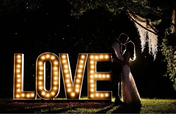 Illuminated LOVE sign at night