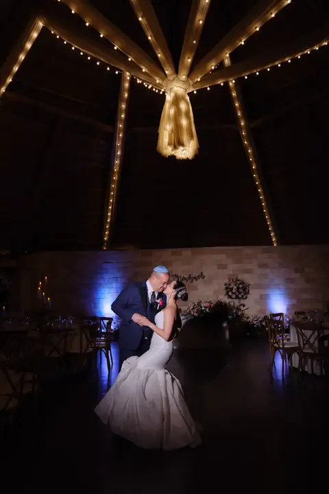 Couple dancing under reception lights