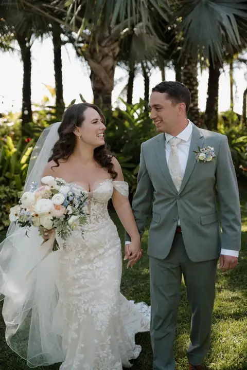 Bride and groom walking in the garden