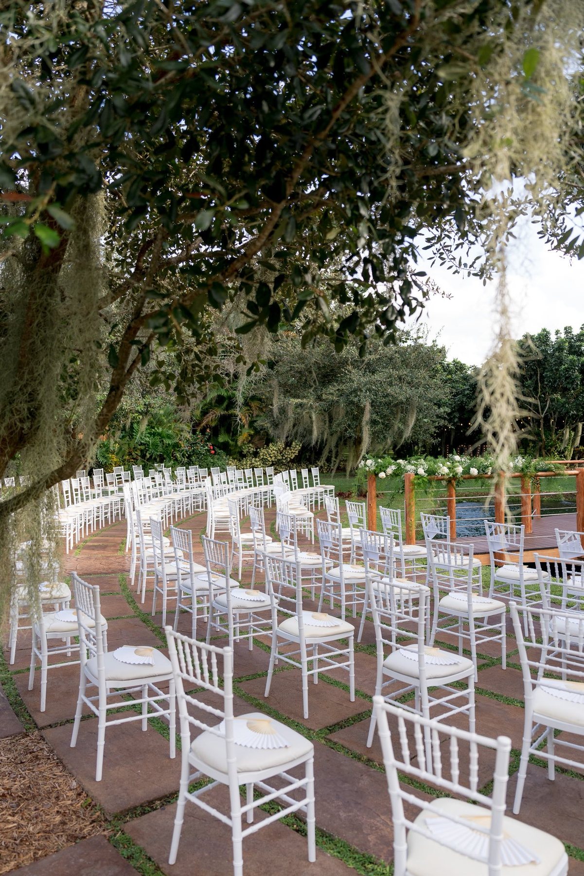 Outdoor ceremony chairs beneath the trees