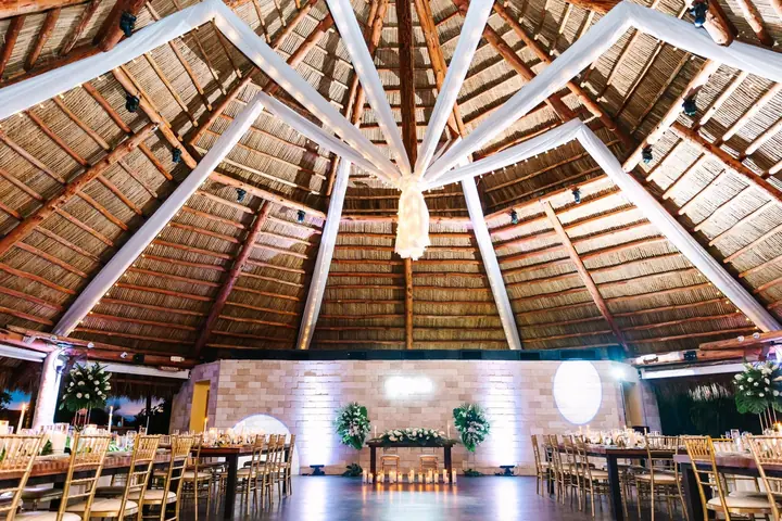 Open air tiki pavilion displays its timber ceiling and dance floor.